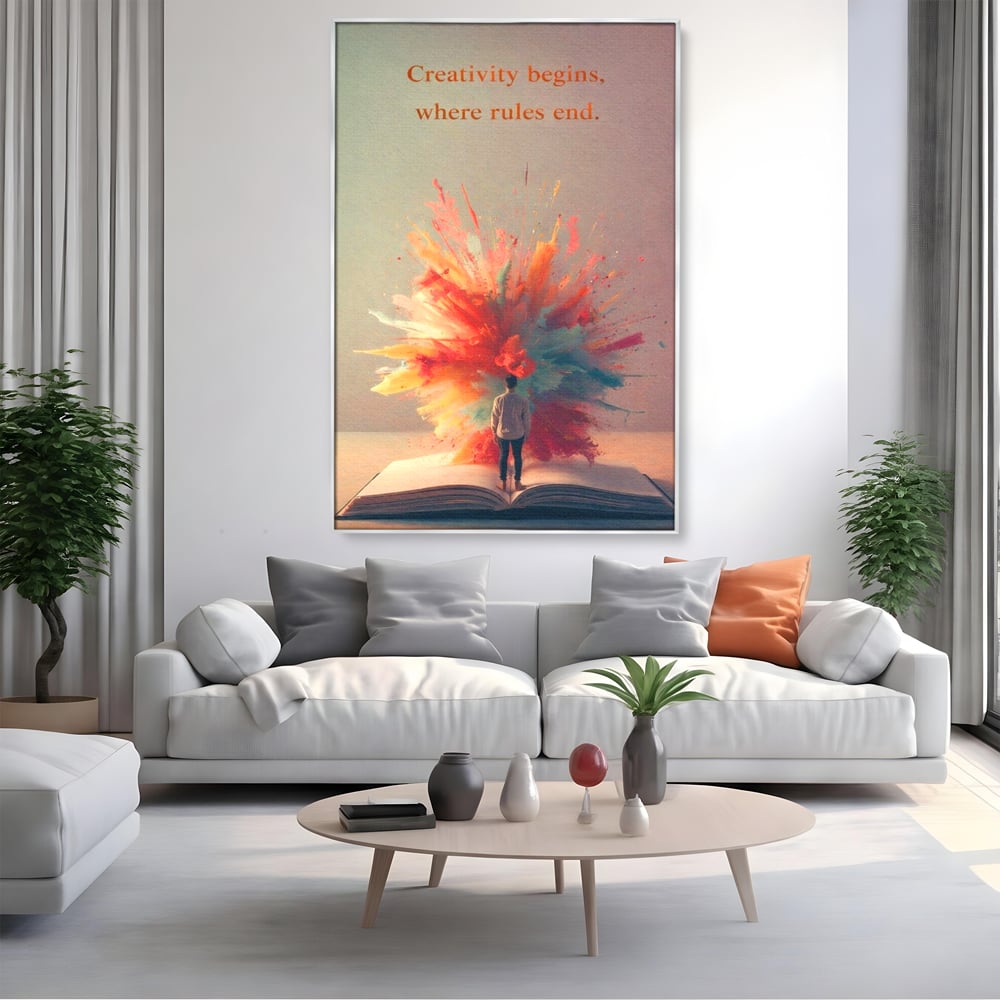 Tablou canvas cu tablou canvas cu barbat privind o explozie de culoare dintr-o carte deschisa, in rama de aluminiu argintiu, pe perete intr-un living